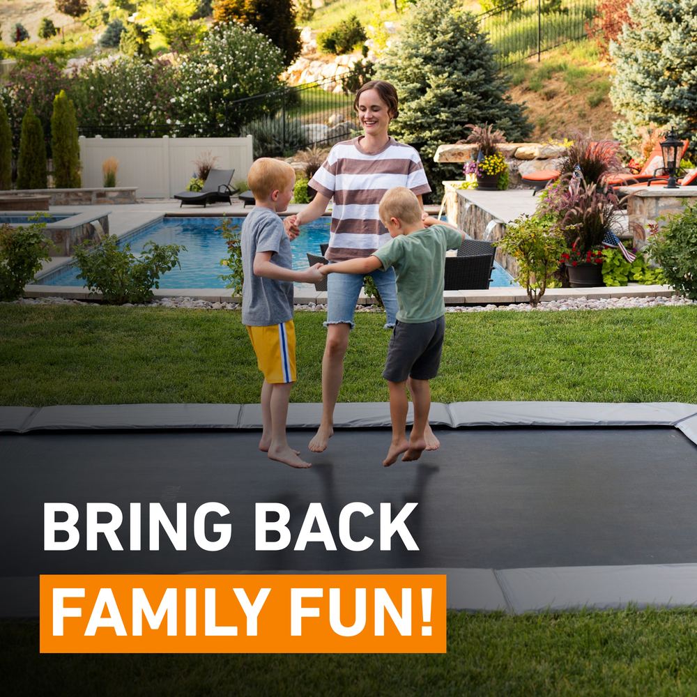 Happy family jumping on an in-ground trampoline