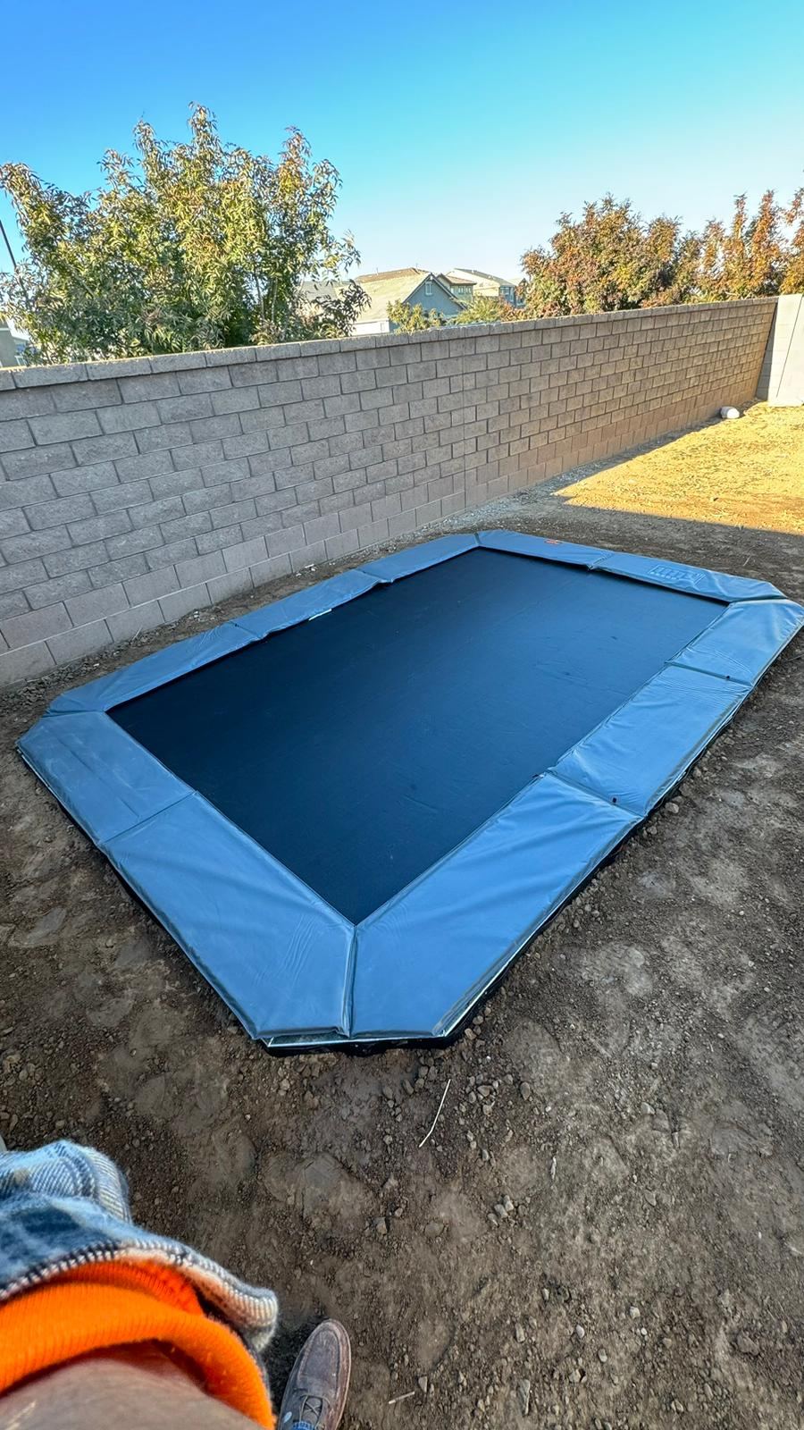 Finished in-ground trampoline set flush with the lawn